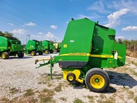      John Deere 582 + 