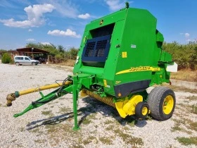      John Deere 582 + 